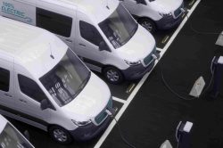 ey-fleet-of-generic-electric-ev-delivery-vans-charging-on-charging-stations
